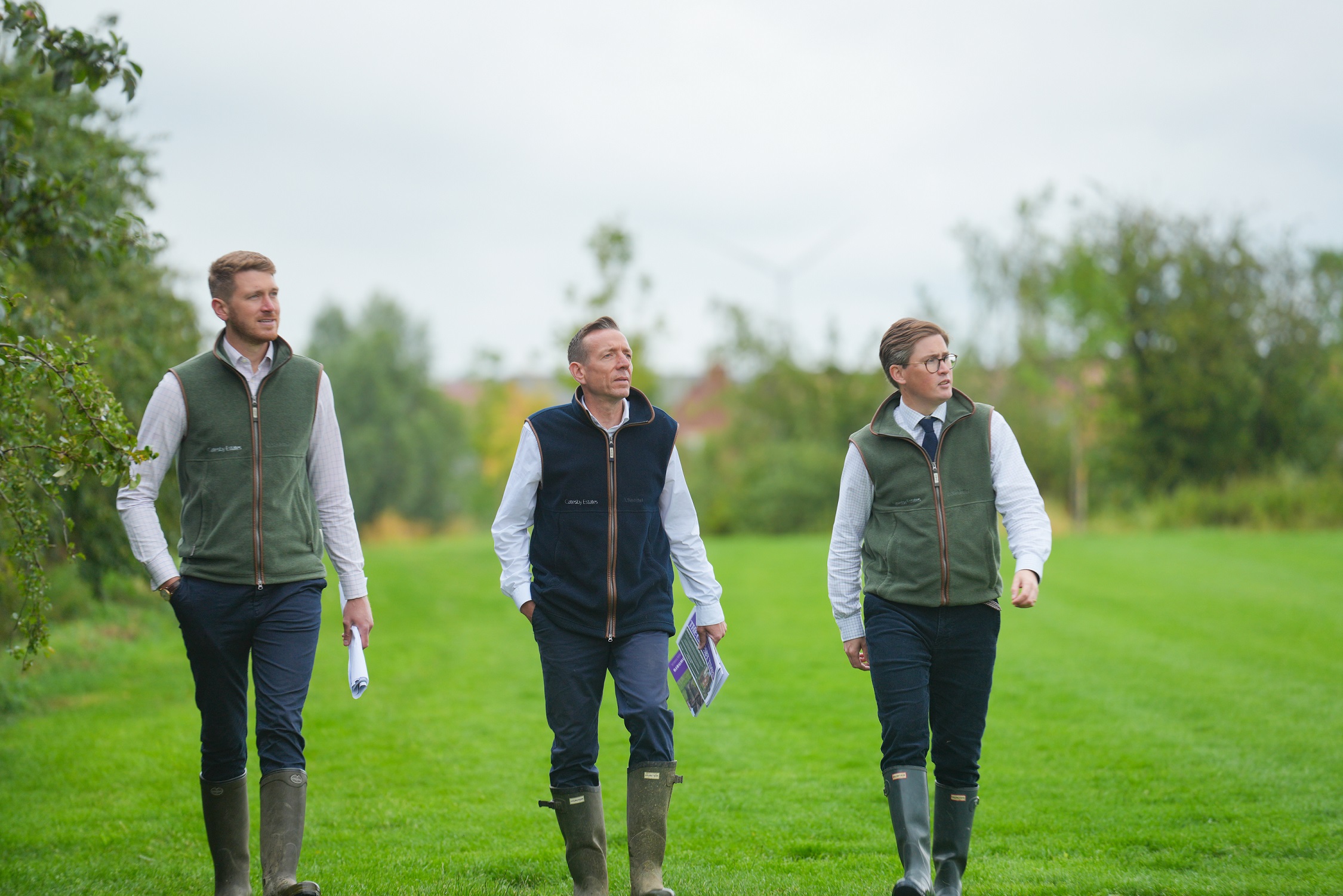 Land promoters walking and assessing a site for future development